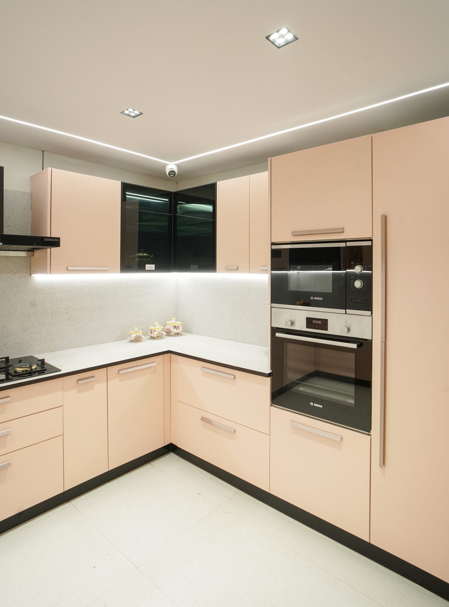 Blush pink gloss modular kitchen with pendant lighting