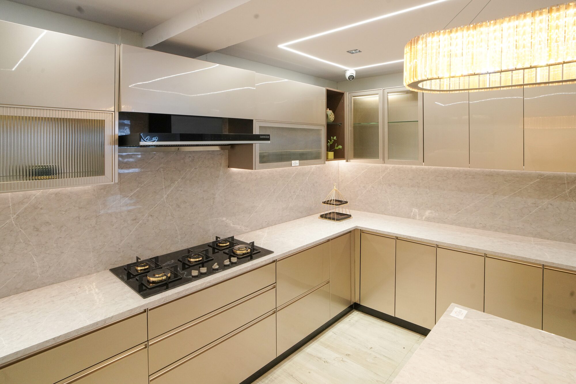Champagne gloss modular kitchen with marble backsplash